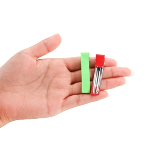 Hand holding green and red ribbon wrapped metal duckbill hair clips for DIY accessories