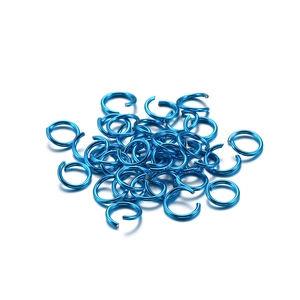 Close-up of electric blue aluminum jump rings for DIY jewelry making and linking projects