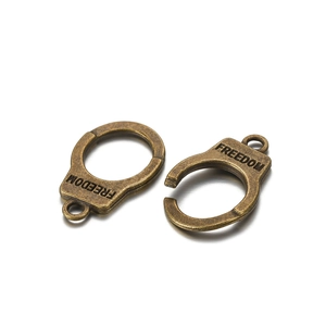 Detailed macro view of vintage bronze handcuff pendant with Freedom engraving
