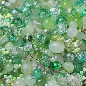 Macro detail of mixed green DIY craft beads in various textures and sizes for jewelry making