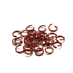 Detailed pile of red antique copper open jump rings for DIY jewelry making and bracelet assembly