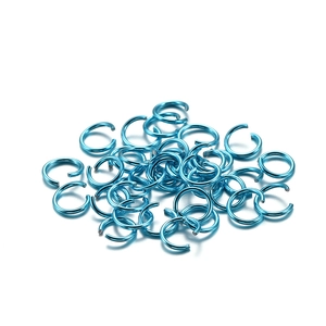 Detailed view of sky blue open jump rings for DIY jewelry making and bracelet assembly