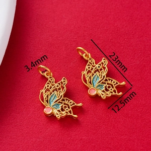 Macro view of gold-plated butterfly pendant with colorful enamel and precise size marks
