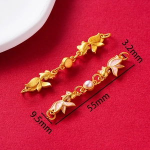 Detailed view of goldfish tassel pendant with pink enamel and pearl on red background
