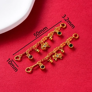 Detailed view of vintage gold-plated butterfly charms with tassels and colorful gems