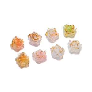 Macro detail of eight colorful resin rose beads with gold-rimmed petals for DIY jewelry