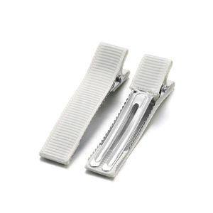 Detailed view of white ribbon-wrapped alligator clips with non-slip metal teeth design