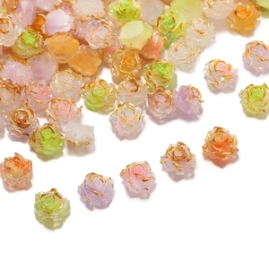 Detailed view of colorful resin roses with gold edges and glitter for DIY nail art and crafts