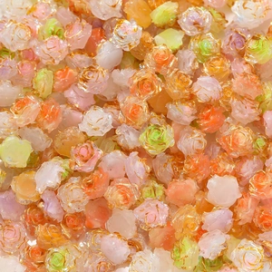 Close-up of assorted resin rose beads with elegant gold-rimmed petals for DIY jewelry