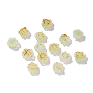 Detailed view of light green resin rose beads with gold-rimmed edges for DIY jewelry making