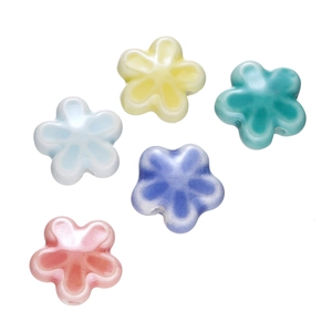 Detailopname van vijf kleurrijke matte bloemkralen van keramiek voor DIY-sieraden