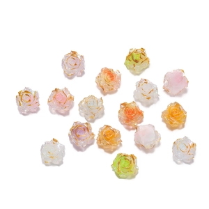 Macro detail of colorful resin rose beads with gold edges and glitter for DIY jewelry