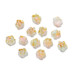 Macro view of resin rose beads with pink gradient and gold gilded edges for DIY crafts
