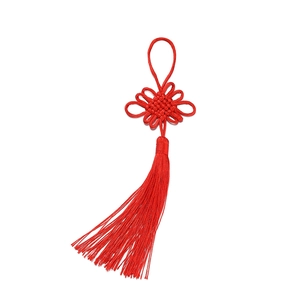 Close-up of red Chinese knot with a lucky tassel made of glossy polyester fiber