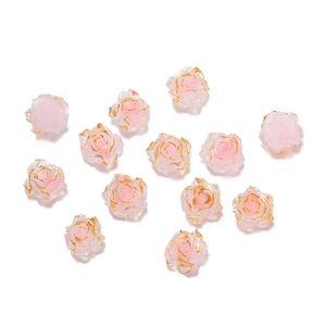 Detailed macro view of pink resin rose beads with gold edges for jewelry DIY