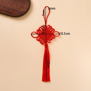 Traditional red Chinese knot pendant with long silky tassel on minimalist beige background