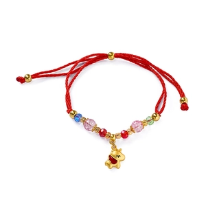 Detail of red braided bracelet with gold unicorn charm and colorful glass beads