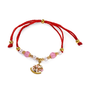 Detail of red woven bracelet with enamel rocking horse charm and colorful beads