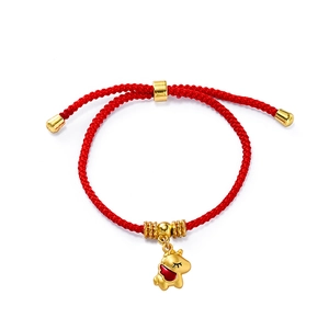 Macro detail of red woven bracelet with golden horse charm and adjustable sliding knot
