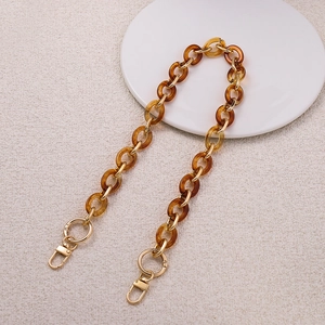 Detail of amber acrylic rings and gold metal buckles for DIY handbag strap replacement