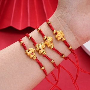 Close-up of four red braided New Year bracelets with golden horse charms and beads