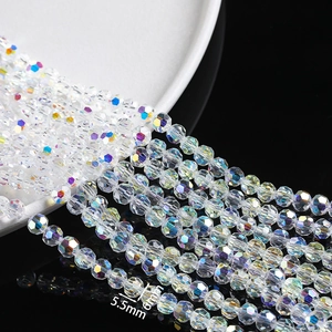 Macro detail of 5.5mm and 6mm faceted crystal glass beads with AB rainbow coating