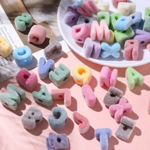 Detail shot of colorful flocked acrylic letter beads for DIY jewelry bracelet making