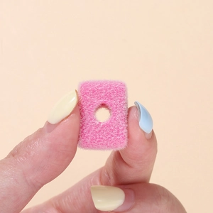 Close-up of a pink flocked rectangle acrylic bead with a large center hole for DIY jewelry