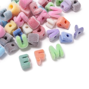 Macro detail of colorful flocked acrylic letter beads with holes for DIY jewelry making