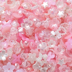 Détail macro de perles fleurs en ABS rose et blanc pour la création de bijoux DIY
