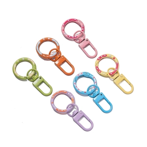 Detail view of 6 colorful macaron paint donut spring rings with rotatable lobster clasps