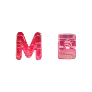 Detail of pink transparent acrylic letter M bead with side hole for DIY jewelry making