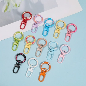 Macro detail of colorful spray-painted donut swivel spring hooks for DIY keychains