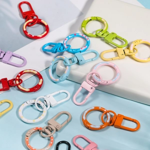 Close-up of assorted colorful metal spring lobster clasps with decorative polka dot rings