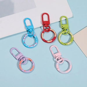 Close-up of five colorful paint-coated spring ring clasps for DIY bag accessories