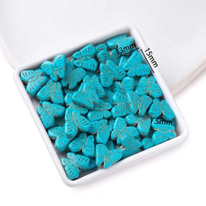 Macro detail of 15mm turquoise butterfly beads with 1.5mm holes for DIY jewelry