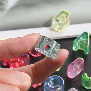 Macro shot of colorful iridescent acrylic letter beads for DIY jewelry with rainbow finish