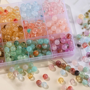 Close-up of 8mm colorful marble texture acrylic beads in a 10-grid clear storage box