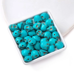 Skull turquoise beads 12.5x10mm in a white dish, jewelry making diy supply detail