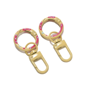 Detail of beige donut spring ring with rotating clasp and colorful sprinkle pattern