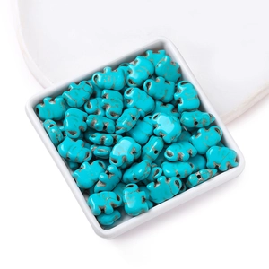 Blue elephant turquoise synthetic beads in a white dish for DIY jewelry making