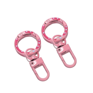 Detail of pink donut patterned spring o-rings with swivel snap hooks for bags