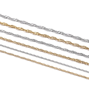 Detailed view of shimmering gold and silver water wave twist chains for DIY jewelry making