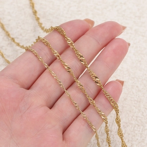 Three different thicknesses of gold titanium steel twisted rope chains shown in hand