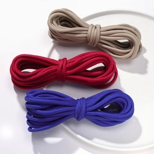 Close-up of 5mm colorful woven nylon cords in beige, red, and blue for DIY crafts