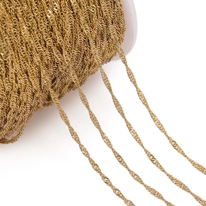 Macro shot of gold twisted chain on a spool for DIY jewelry making and crafts