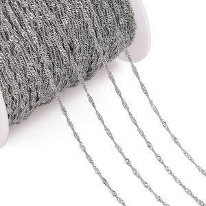 Macro shot of silver titanium steel water wave chain on a spool for DIY jewelry making