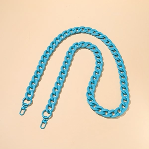 Macro view of bright blue acrylic flat Cuban chain with lobster clasp for handbags