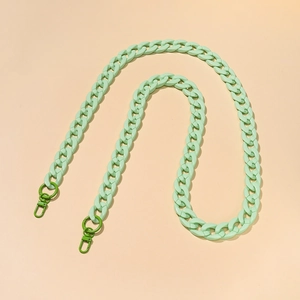 Detail of mint green acrylic handbag chain link with forest green metal lobster clasps