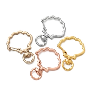 Set of shell shaped alloy keychains in four metallic colors with swivel ring clasps